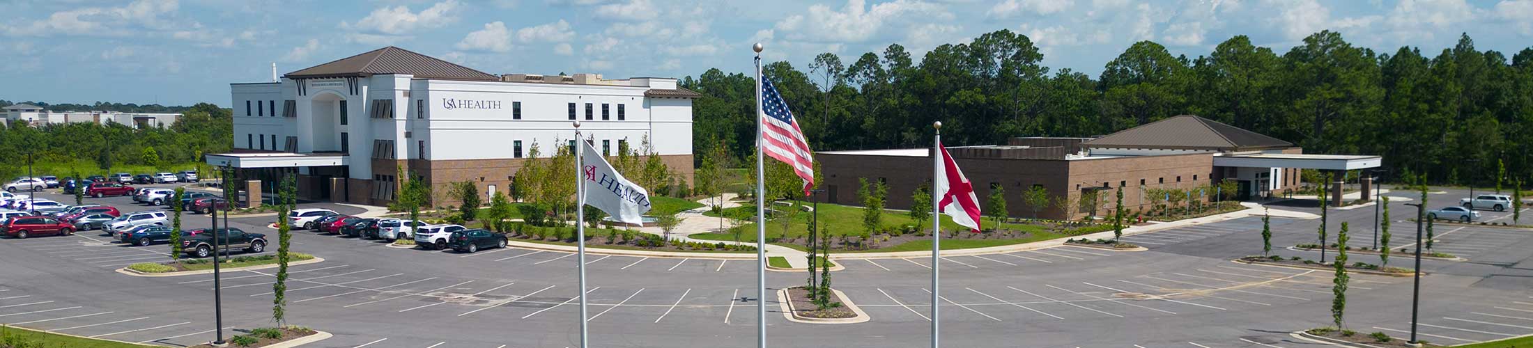 ý Health facility with flags in front.